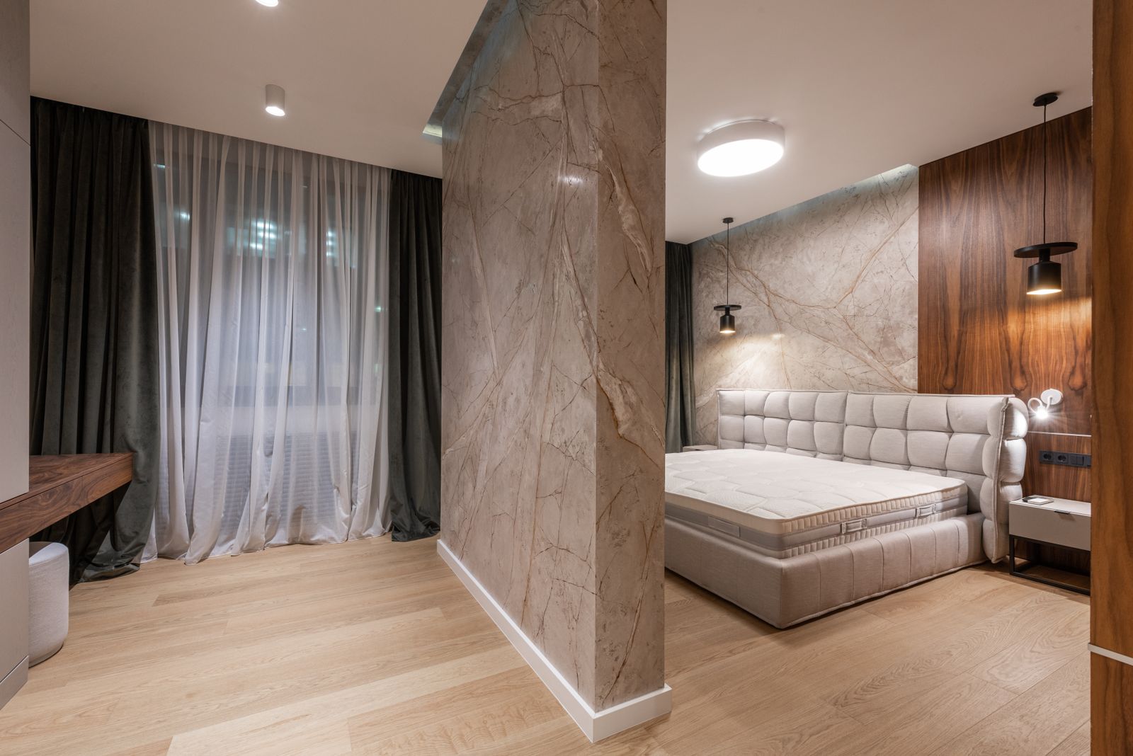 Luxury suite with millwork desk and marble finishes